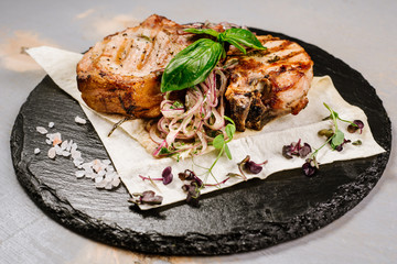 Tasty roasted steak with spices on the wooden background