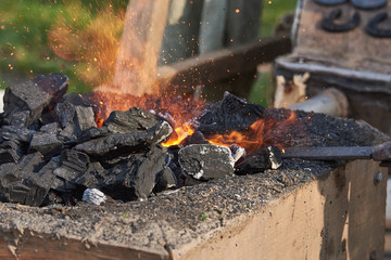 The heating of metal billets on hot coals before forging