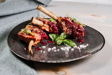 Grilled ribs with red sauce on the wooden background