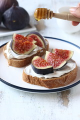 Sandwich with figs and honey,  cream cheese,honey and bread slice