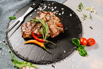 Tasty roasted steak with spices on the wooden background