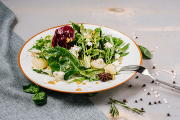 Fresh tasty green salad on the wooden background