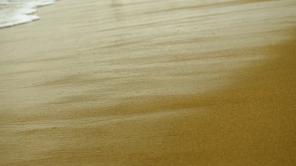 Close-up shot of wave breaking on sandy shore of Mediterranean sea. Greece. 4K