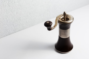 Ancient pepper mill on white background.