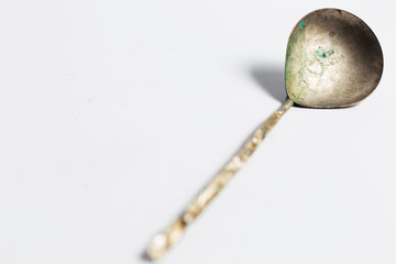 Ancient spoon on white background.