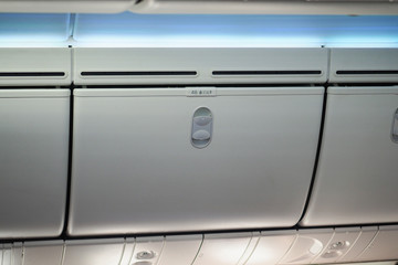 Luggage shelf in an airplane. Aircraft interior. Travel concept.