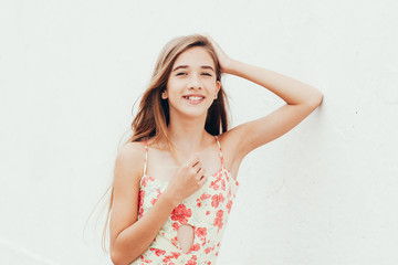 Outdoor portrait of 12 years old girl with long hair