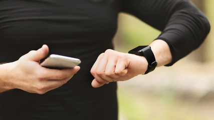 Obraz na płótnie Canvas Man using fitness app on his smartwatch