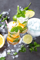 Mohito lime drinks on wooden with blur beach background. Fresh drinks with fruits on wood. Summer concept