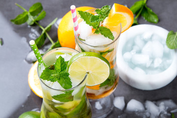 Mohito lime drinks on wooden with blur beach background. Fresh drinks with fruits on wood. Summer concept