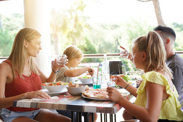 Family on vacation having dinner at the restaurant