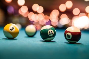 Colorful billiard balls on table close up