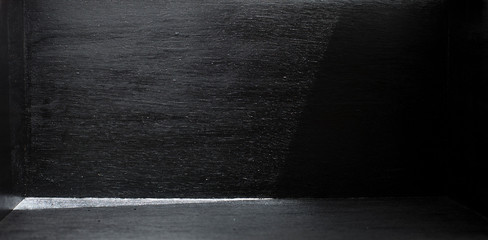 Light and shadow in a black room with empty space