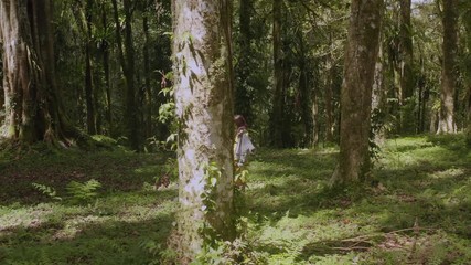 Woman strolling in tropical forest
