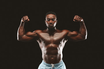 Fototapeta na wymiar African american athlete showing muscular hands and shoulders