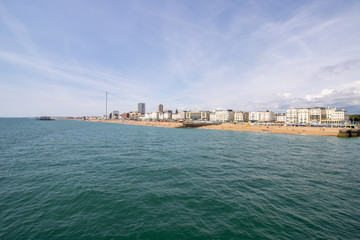 Fototapeta premium Brighton UK, 10th July 2019: The famous beautiful Brighton Beach and Seafront showing the coastline area on a bright sunny day,