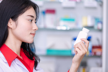 asian female pharmacist in the pharmacy health care concept