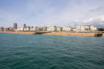 Fototapeta premium Brighton UK, 10th July 2019: The famous beautiful Brighton Beach and Seafront showing the coastline area on a bright sunny day,