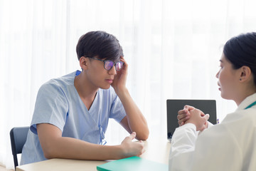 Young Asian patient men talking with the doctor in the hospital, health care and medical.