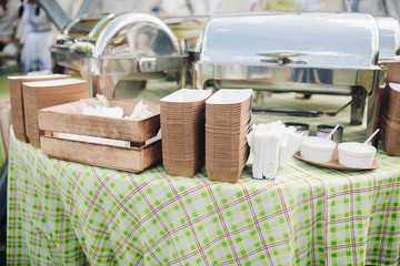 Stock photo of paper recyclable containers in stacks on the table over patterned green and white...