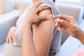 Pregnant women get flu and measles vaccine shot, medicine and drug concept