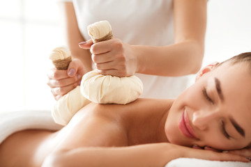 Obraz na płótnie Canvas Herbal massage. Masseur doing massage for deep relaxation