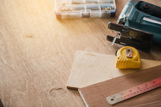 Carpenter working on woodworking machines in carpentry shop.The carpenter in workshop marks out the details of the furniture cabinet.