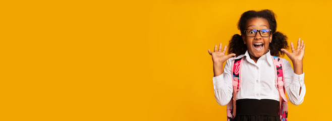 Surprised African American Schoolgirl Screaming On Yellow Background