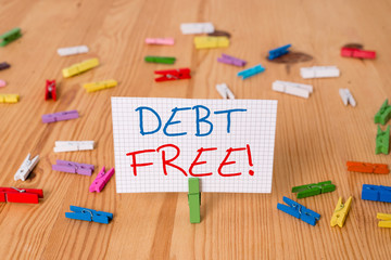 Text sign showing Debt Free. Business photo text does not owning any money to any individual or companies Colored clothespin papers empty reminder wooden floor background office
