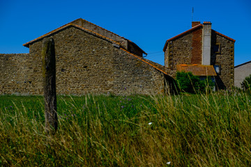 Fototapeta premium French farming village buildings with blue sky