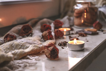 autumn flat lay on the windowsill, in a composition with flowers and candles, chocolate cookies and spices,noise, film grain, compression artifacts, retro