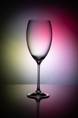 Empty wine glass goblets on a colored background abstract