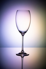 Empty wine glass goblets on a colored purple background abstract