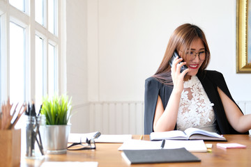 businesswoman  freelancer woman talking on smart mobile phone at office.