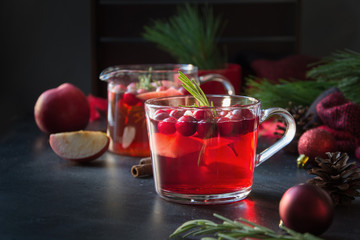 Christmas cranberry and apple mulled wine garnish rosemary and fir branches on black. Xmas drink.