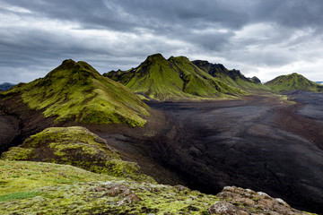 Landscape in Iceland. Green mossy mountains and lava fields in Landmannalaugar national park in Iceland.