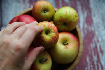 Autumn apples bowl wooden background hand
