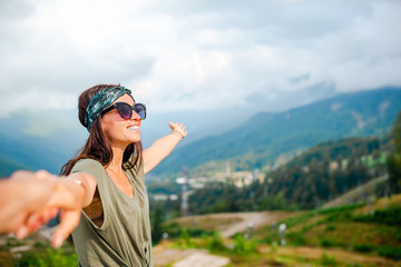 Beautiful happy young woman in mountains in the background of fog © travnikovstudio