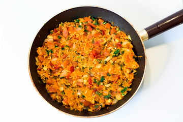 vegetable stew in a frying pan on a white background