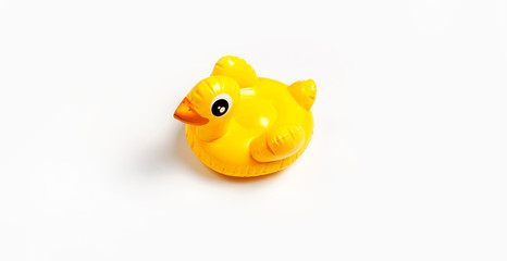 Inflatable mini yellow chicken or duckling on white background, pool float party. Flat lay copy space. Trend Inflatable Children toy for swimming. Creative summer beach concept. Layout for design