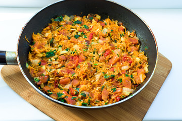 vegetable stew in a frying pan on a white background
