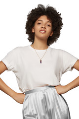 The medium front shot of a young mulatta lady with a golden chainlet with a pendant in the form of screw with a fitted-in violet gemstone similar to a jadeite on her neck.  © RedUmbrella&Donkey