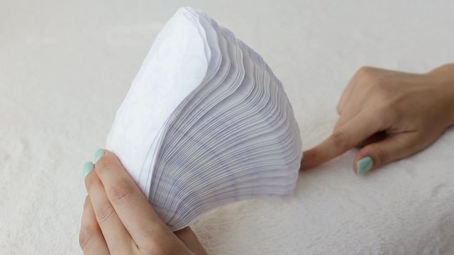 Girl fingering daily sanitary pads concept of cleanliness and hygiene, close-up, menstruation