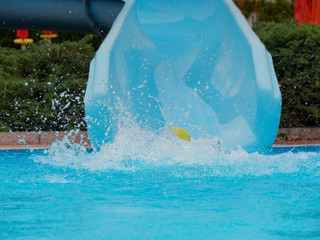 boy rides water slide rides at the water park