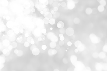 Naklejka na ściany i meble Abstract background with White bokeh on gray background. christmas blurred beautiful shiny Christmas lights.