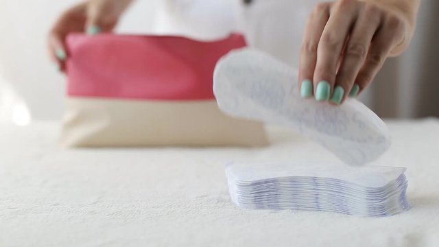 Girl puts daily sanitary pads in her handbag, pantyliner