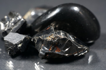 A black rock also called healing stone shungite, which consists mainly of carbon was photographed here in top quality.