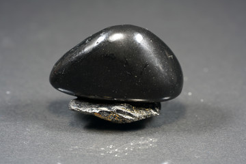 A black rock also called healing stone shungite, which consists mainly of carbon was photographed here in top quality.