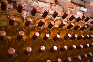 expensive bottles of white dry wine. bottle warehouse in an old wine cellar