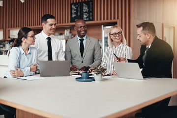 Diverse group of smiling businesspeople working at an office tab